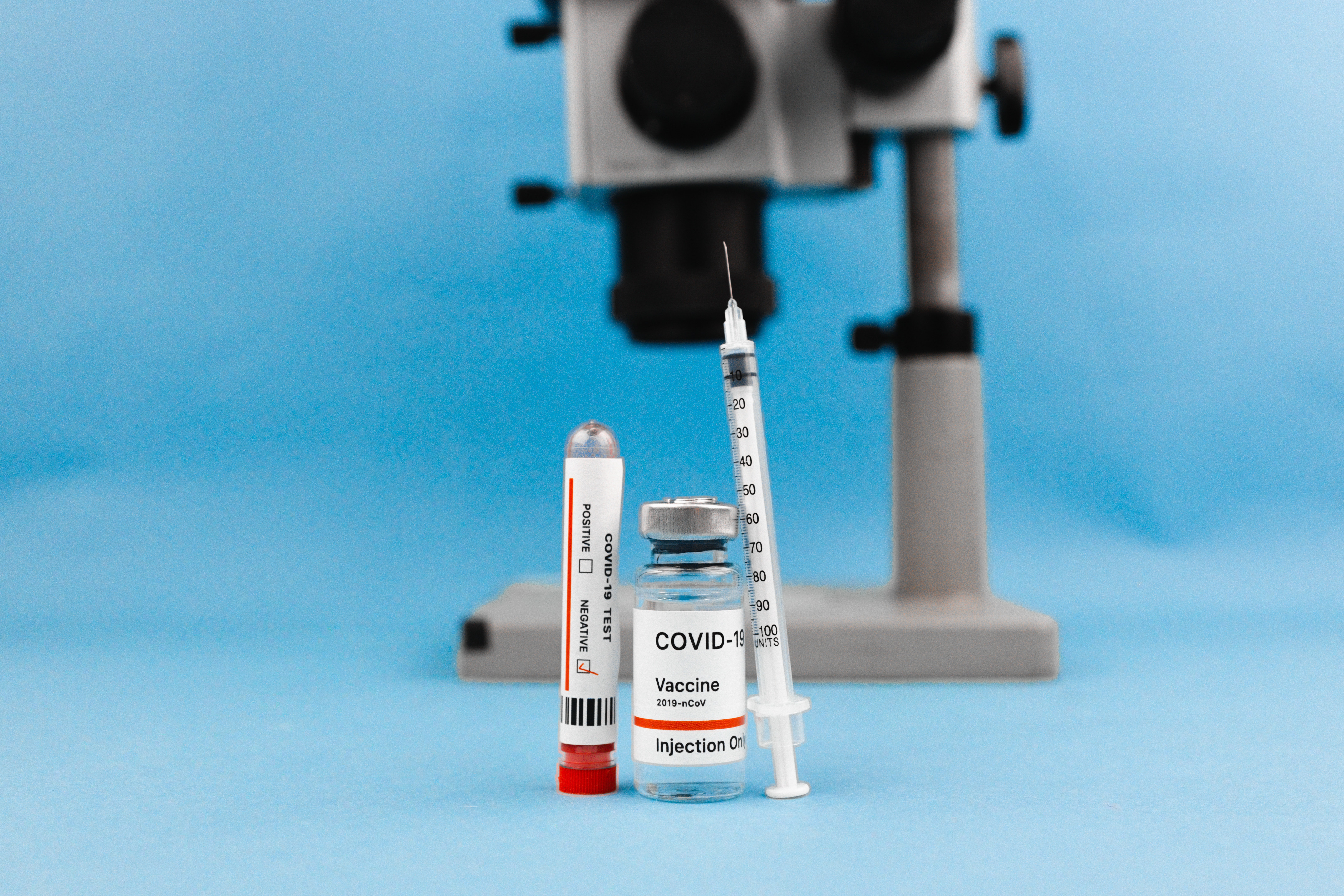 Microscope, vaccine vial and syringe for clinical research and clinical trials. Biomedical research equipment